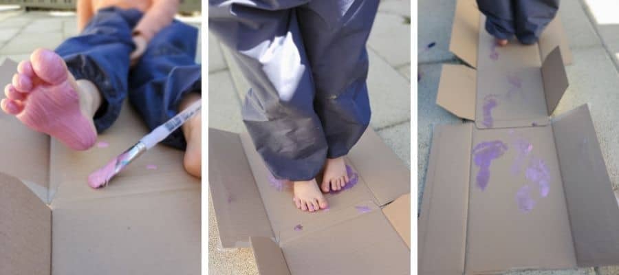 Toddler and young child with paint on their feet walking on carboard: sensory feet play