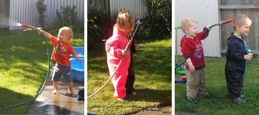 Young children enjoying outdoor play with water and hoses