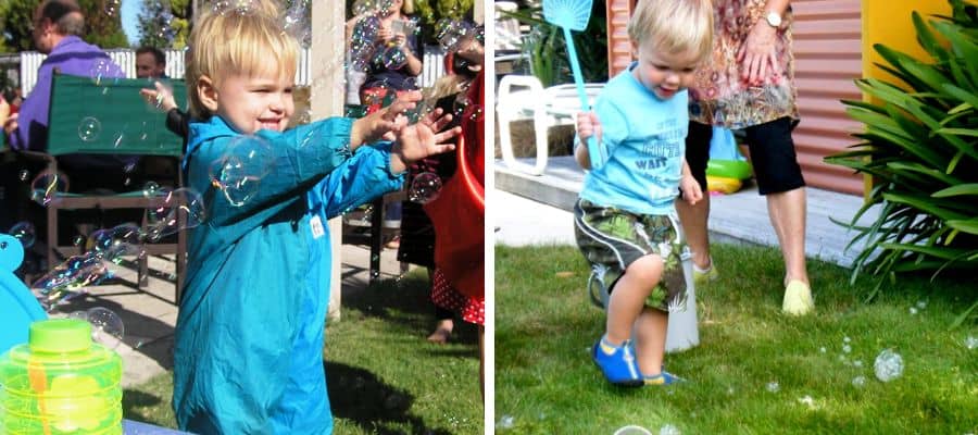 Two toddlers playing with bubbles - a fun outdoor play activity for children