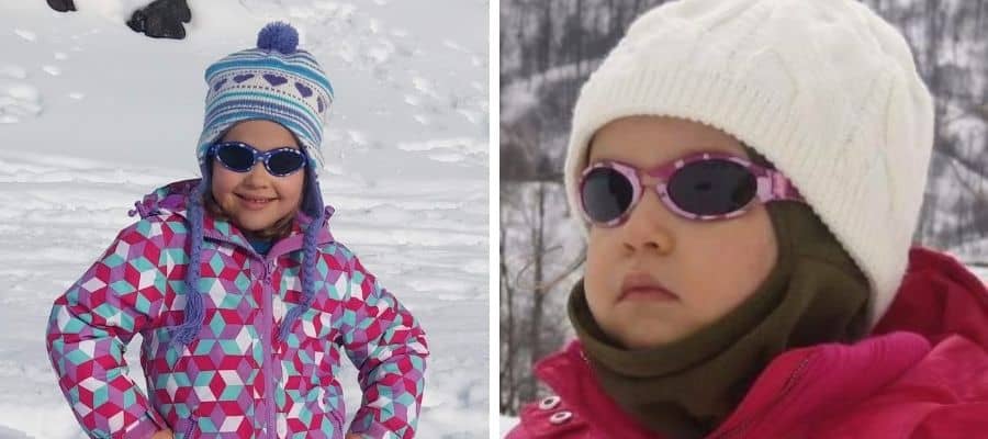 2 young girls wearing sunglasses for their first time on the snow